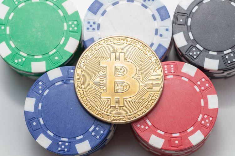 bitcoin and casino chips on a table